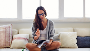Girl daily planning on a sofa