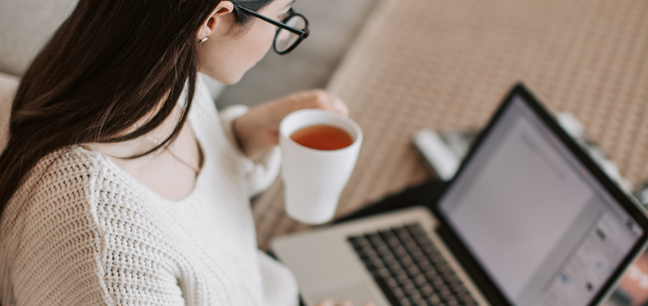girl working while drinking tea